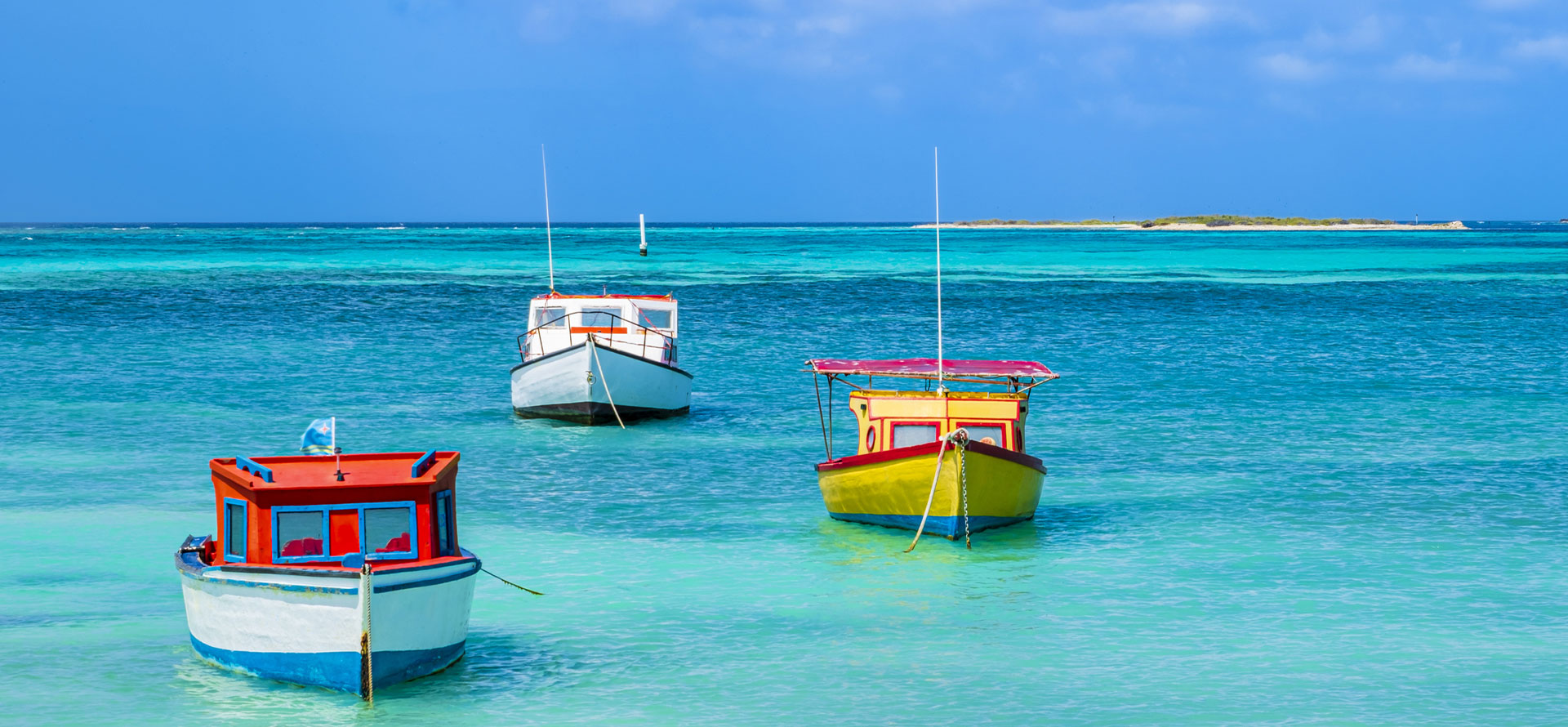 Caribbean vs bahamas boats on a beach.