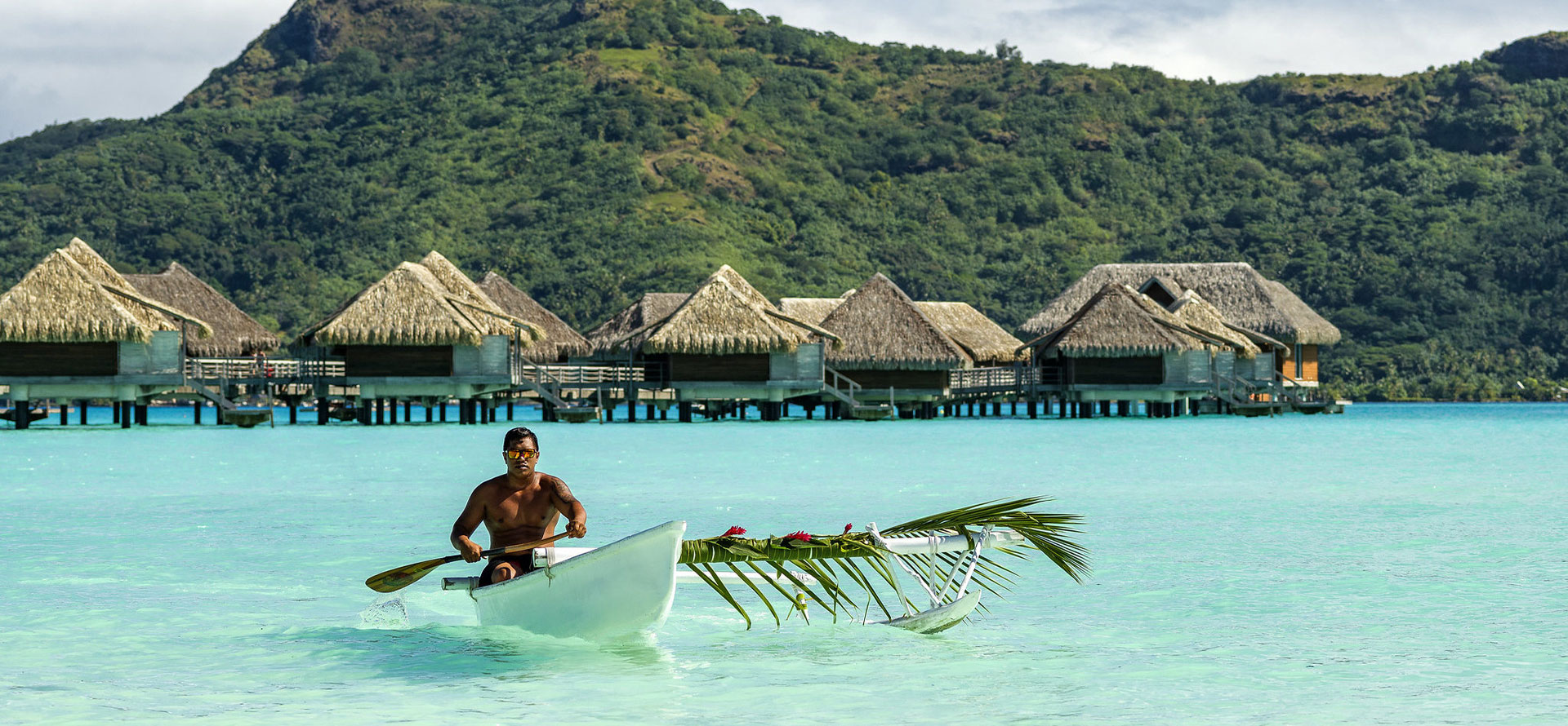 Bora Bora all-inclusive resorts adult-only man on a boat.