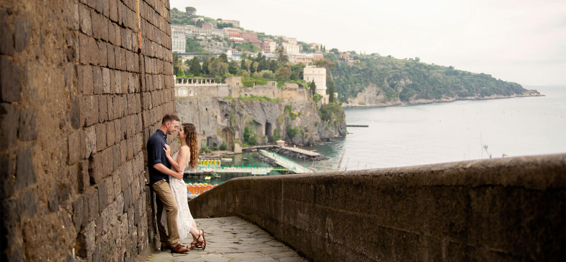 Couple on the waterfront in Amalfi Coast.