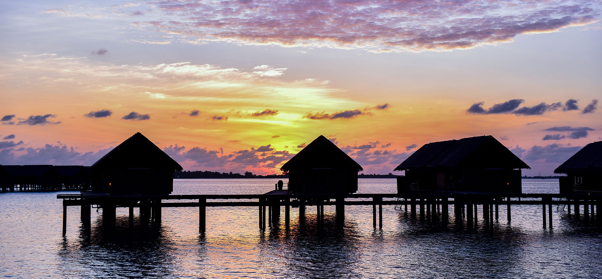 Bora Bora overwater huts at sunset.