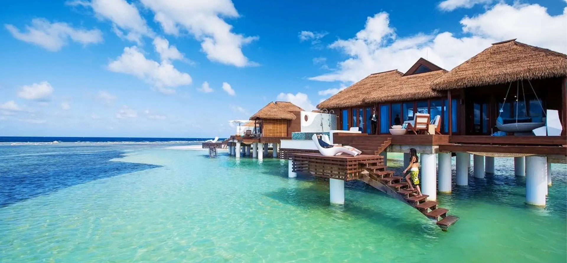 Caribbean overwater bungalows with stairs.