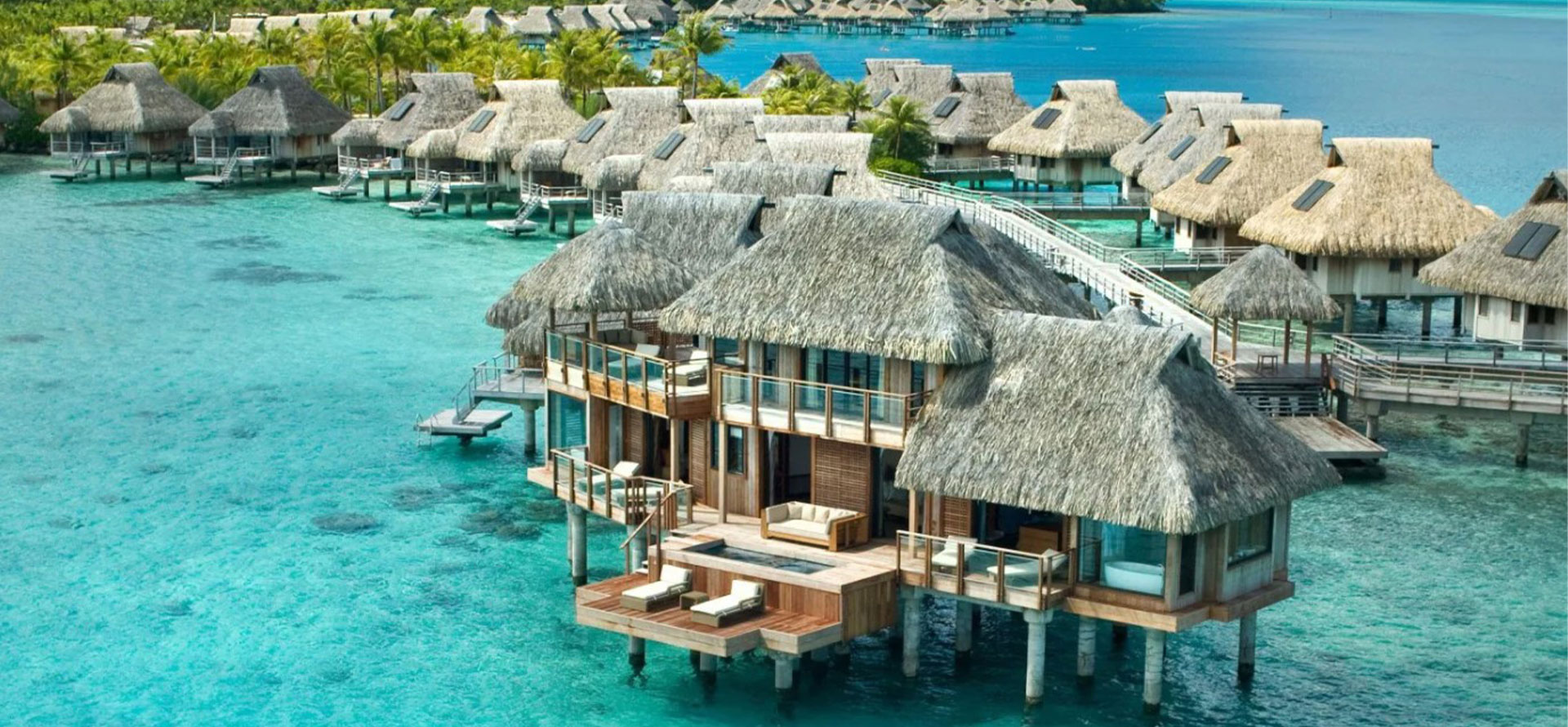 Over the water huts in caribbean with glass floors.