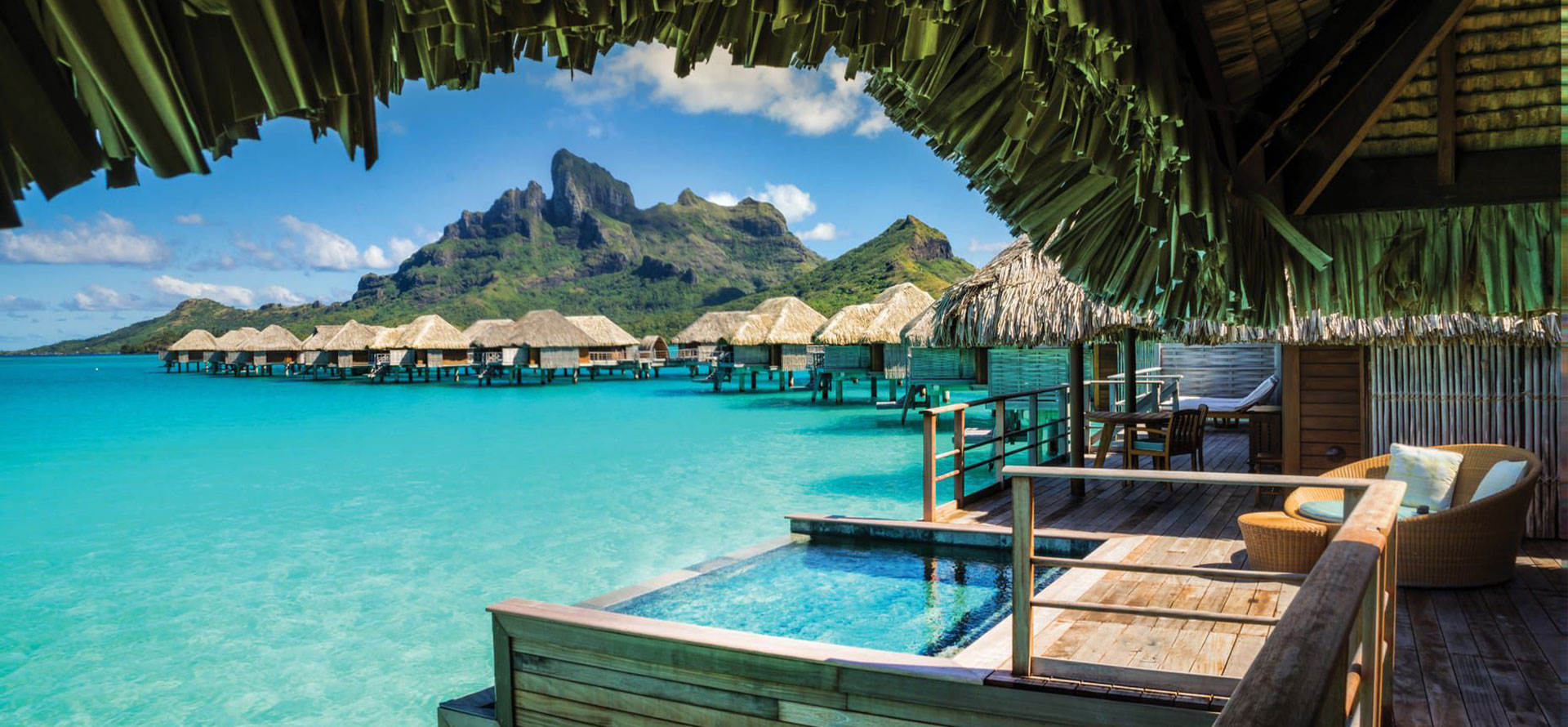 Overwater bungalows in the сaribbean with mountain view.