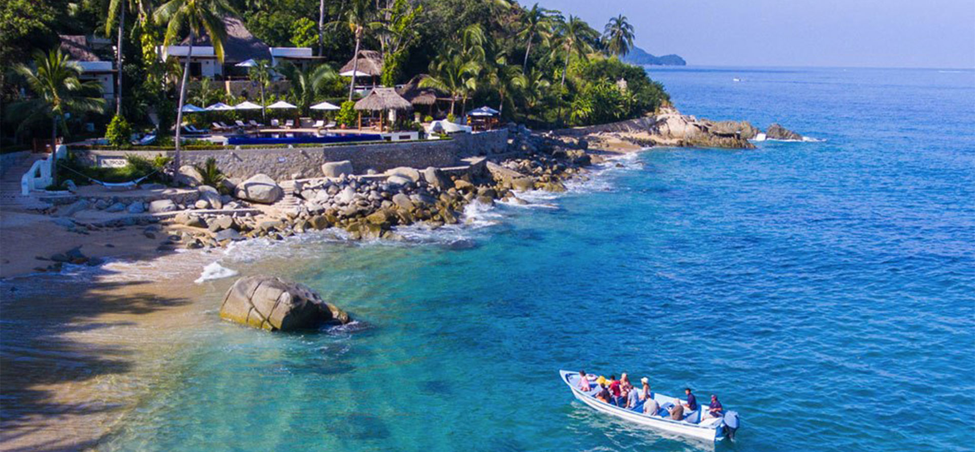 Puerto vallarta and cancun boat near beach.